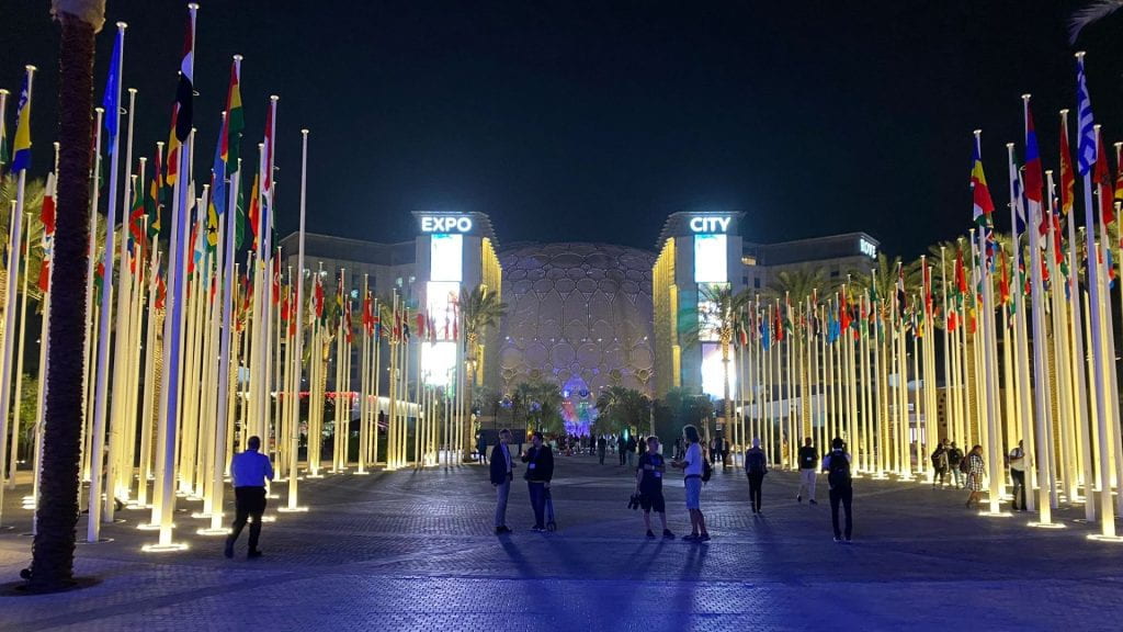 COP28 national flags at night in Dubai.